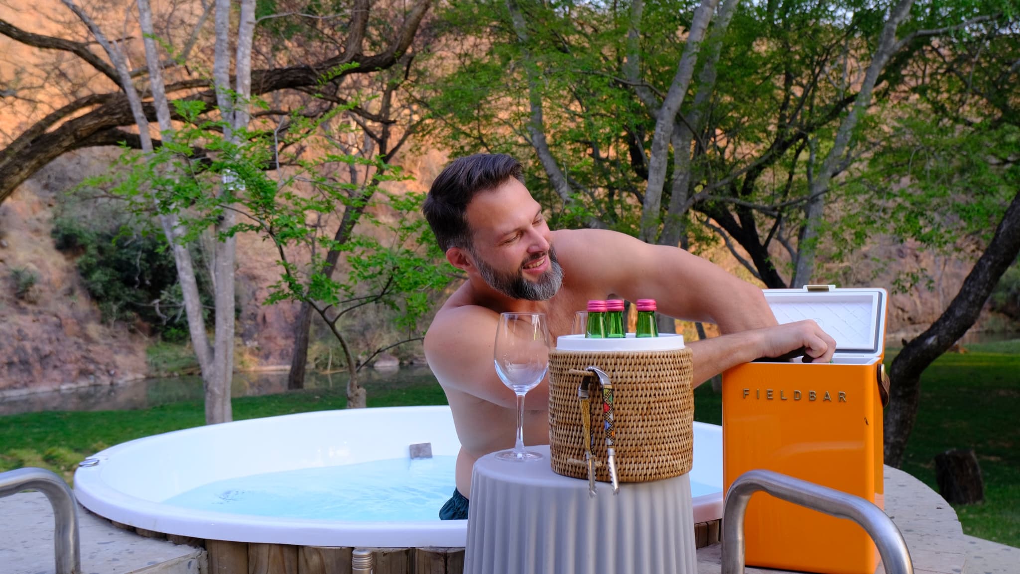 Guest in private hot tub with river view